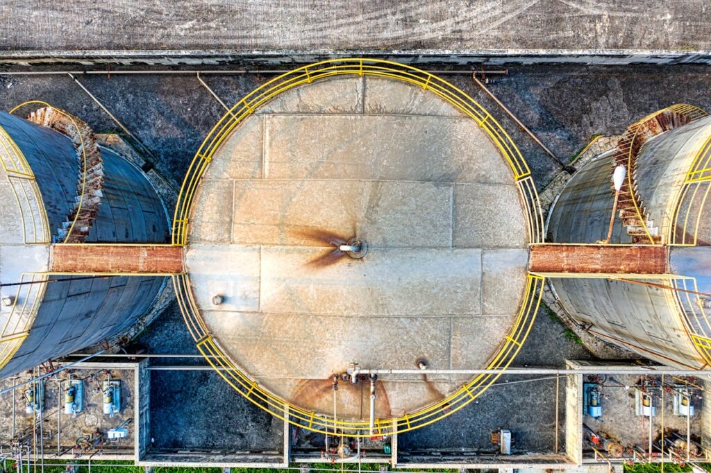 pexels-photo-6048400 Top view of huge industrial tanks connected with rusty passages located at territory of factory
